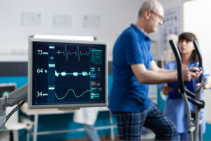 A nurse is utilizing an ECG machine to assess treatment options in a hospital.