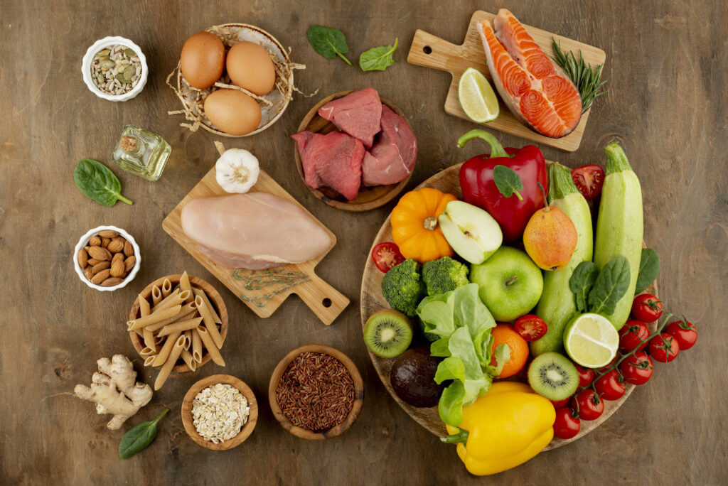 A variety of healthy foods on a wooden table, promoting managing cholesterol.