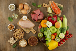 A variety of healthy foods on a wooden table, promoting managing cholesterol.
