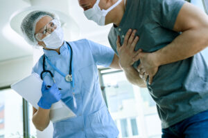 A nurse is examining a patient's chest for symptoms of AF.