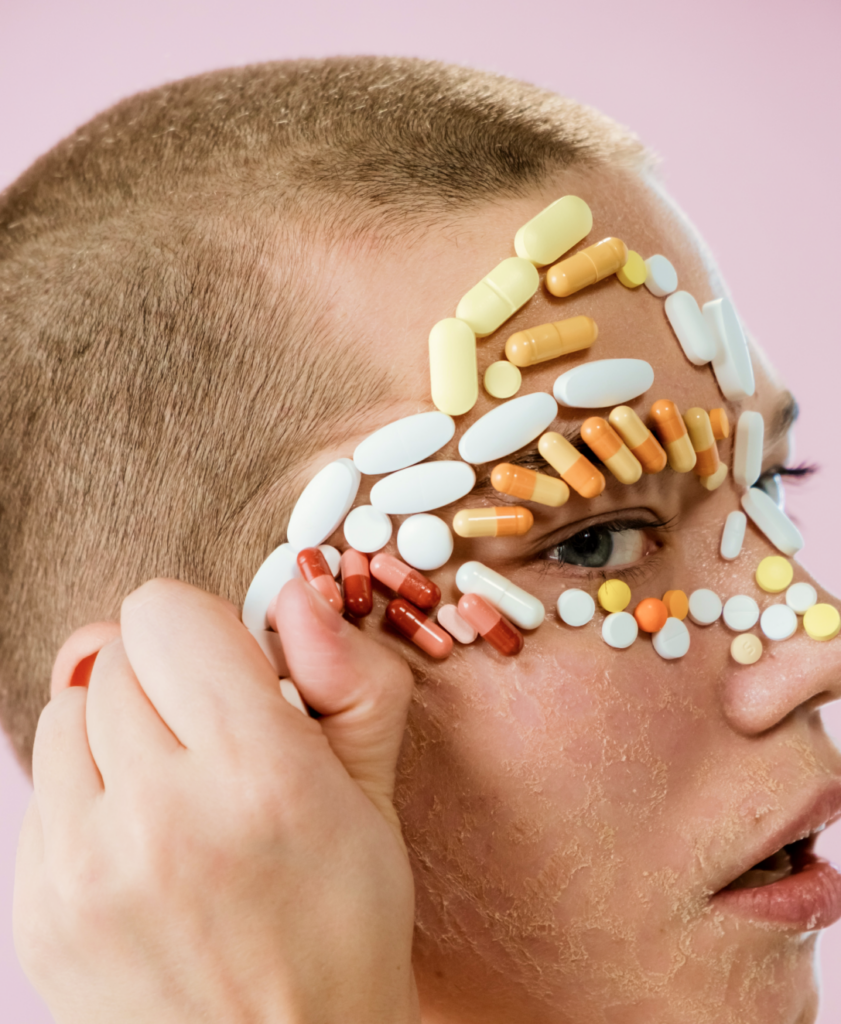 a woman with pills on her face.
